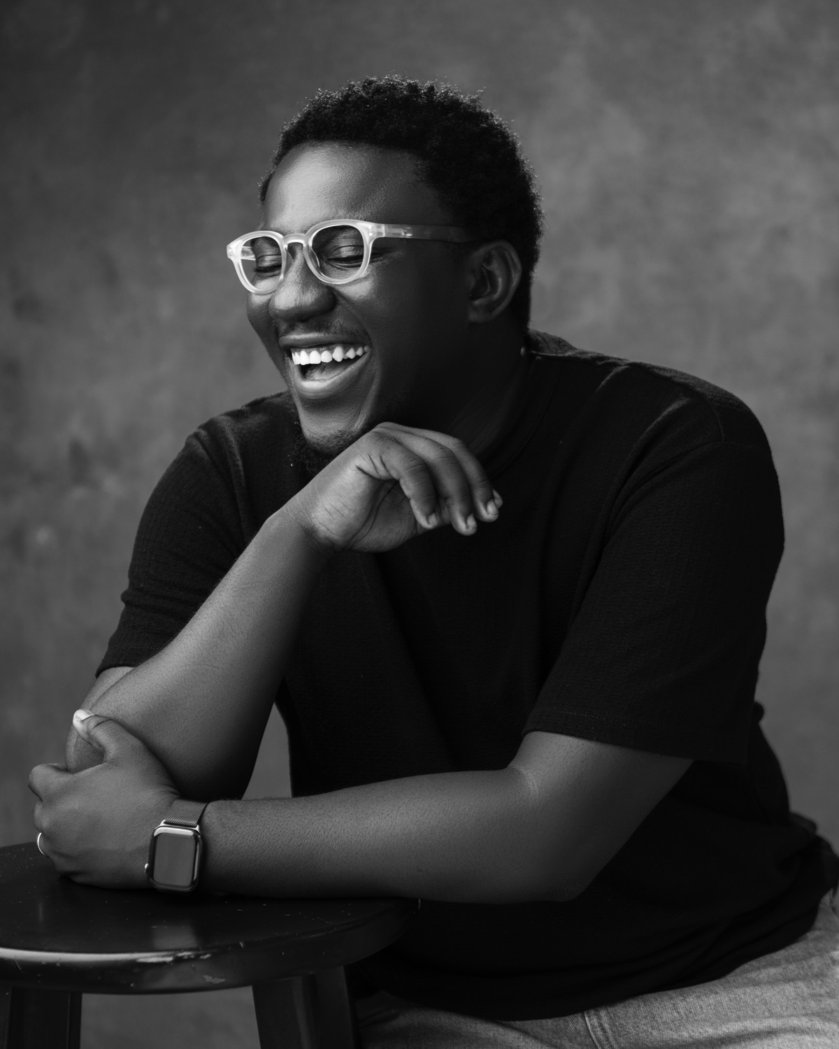 Salem King laughing with his chin resting on his hand
